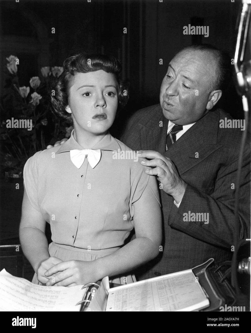 Director ALFRED HITCHCOCK with his actress daughter PAT / PATRICIA HITCHCOCK on set candid during filming of STRANGERS ON A TRAIN 1951 novel Patricia Highsmith screenplay Raymond Chandler Warner Bros. Stock Photo