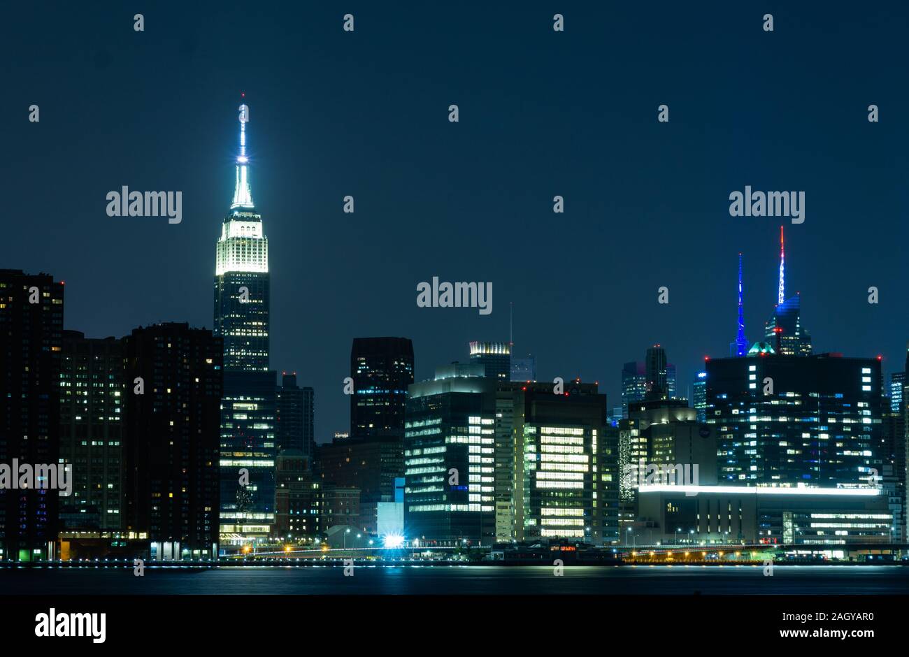 Long time exposure of New York City Manhattan midtown skyline at night viewed from Transmitter Park Stock Photo