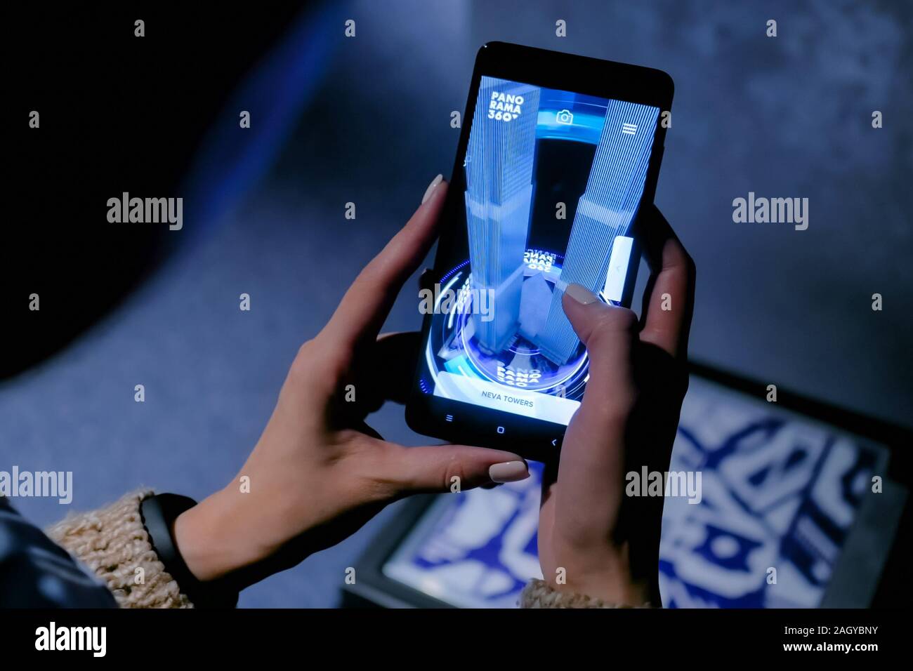Woman using smartphone with architecture augmented reality app Stock Photo