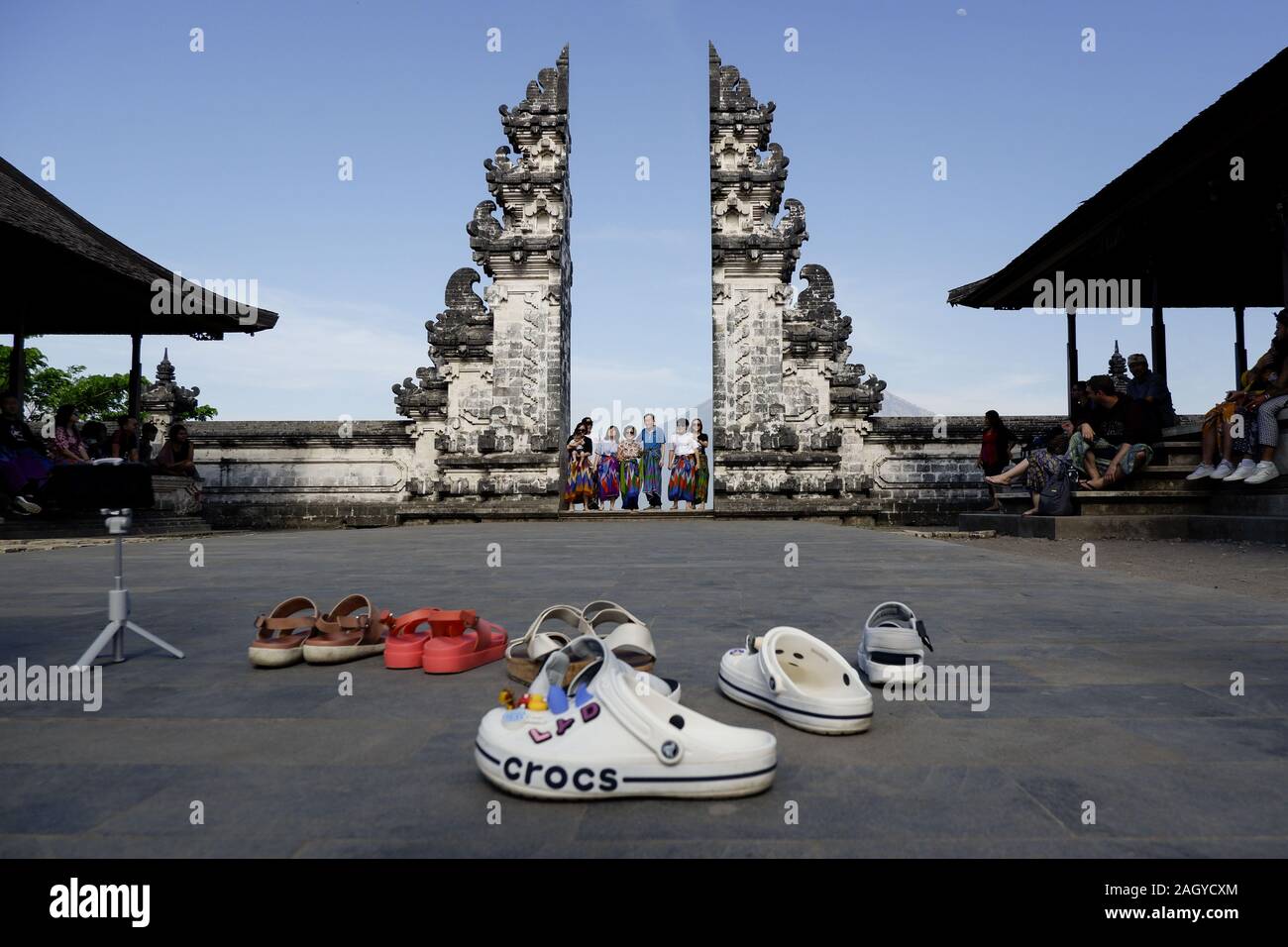 Bali, Indonesia. 20th Oct, 2019. A family poses for a photo at the Gates of Heaven in Bali.Every day thousands of people gather and wait for their turn to take photos at the Lempuyang temple in Bali. The temple became famous for the photos taken at the ''Gates of Heaven'' But the photograph hides a secret. The reflection resembling water seen in the thousands of photos shared on social networks is fake and manipulated. Credit: Hugo Amaral/SOPA Images/ZUMA Wire/Alamy Live News Stock Photo