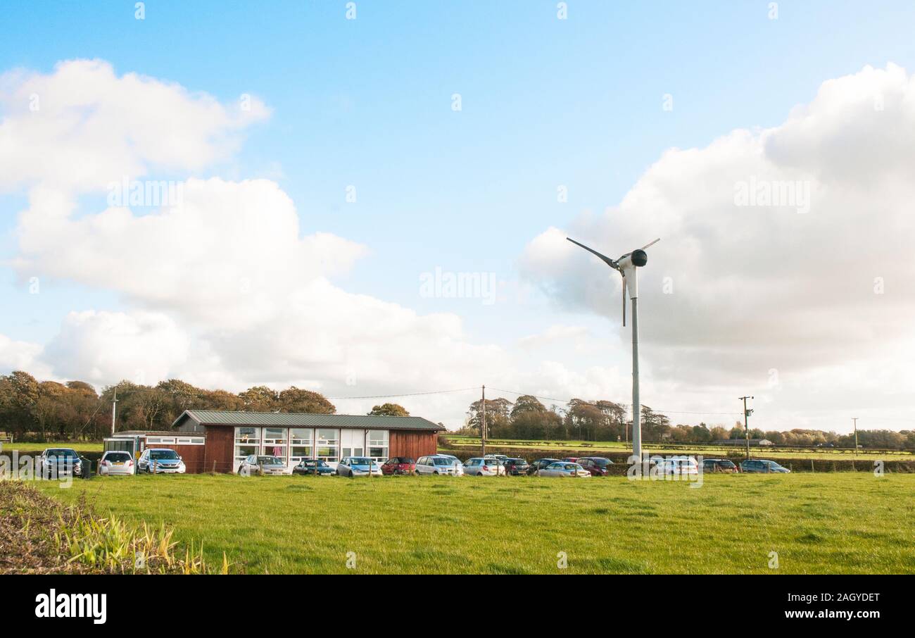 Small wind turbine being used to produce electricity to Out Rawcliffe Village Hall Lancashire England United Kingdom Stock Photo