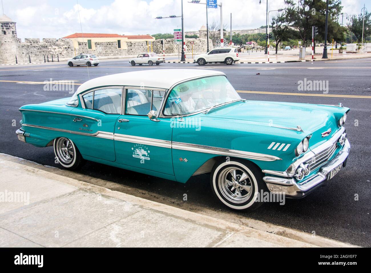 A classic, vintage car, painted turquoise, parked in the Old Town part  of the city of Havana, Cuba Stock Photo