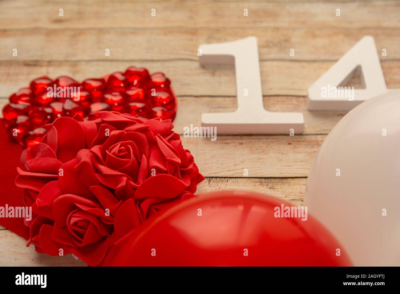 Wooden background with hearts, flowers, balloons and wooden numbers of dated 14 February. The concept of Valentine Day. Top view with space for your g Stock Photo