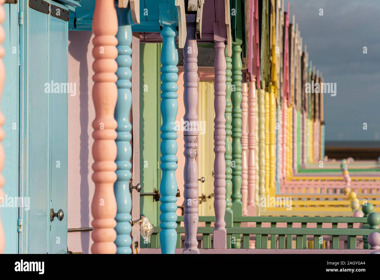 Colourful wooden beach huts at West Mersea, Mersea Island, Essex, UK