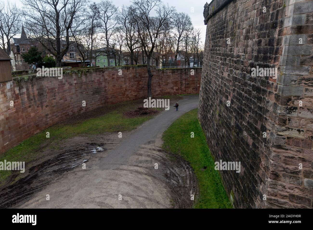 Nuremberg historical castle is very well preserved. Person walking the dog gives comparison to the amazing height of defensive wall. Stock Photo