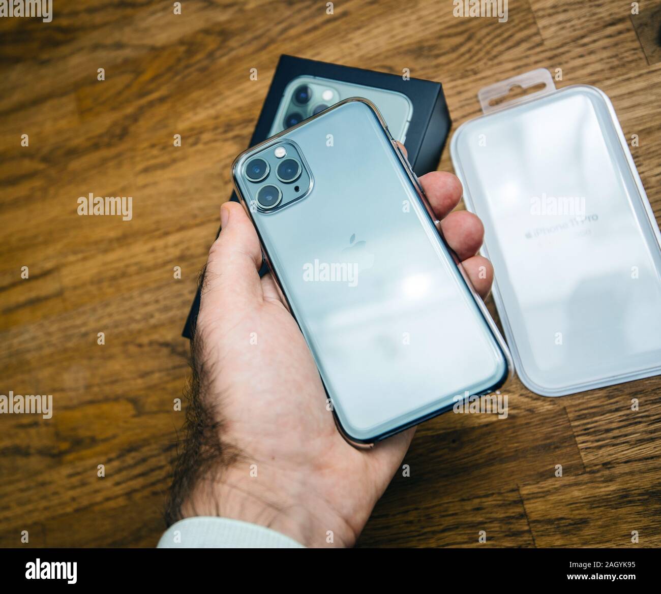 Paris France Oct 4 19 Man Hand Holding Latest Apple Computers Triple Lens Iphone 11 Pro With Green Color Transparent Clear Case Case After Unboxing Stock Photo Alamy