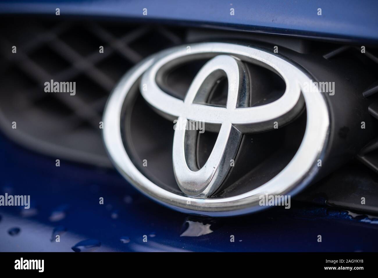 Close up of a silver metal Toyota logo at the front of a Toyota car Stock Photo
