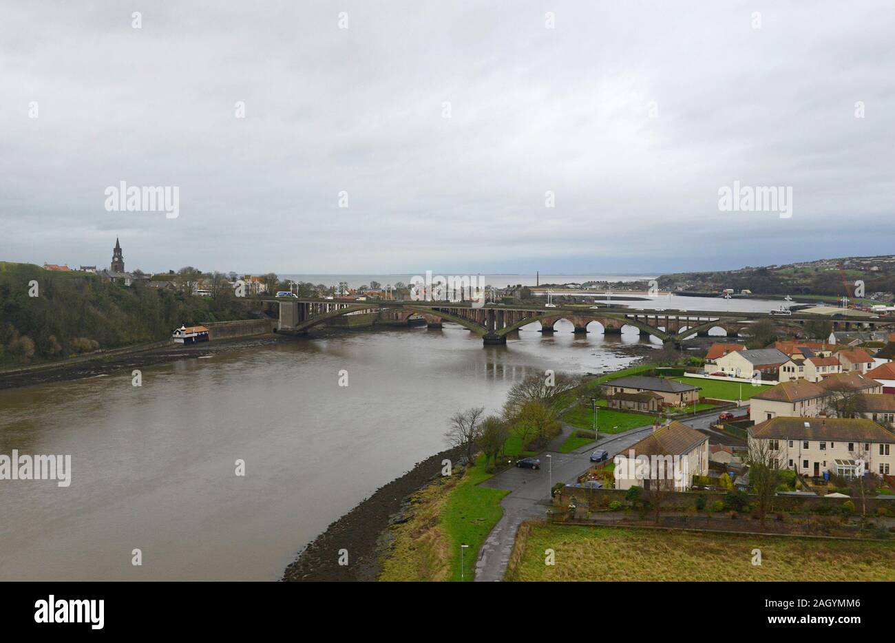 View of Berwick upon Tweed town and the Tweed river from the train on a rainy day in mid December. Stock Photo