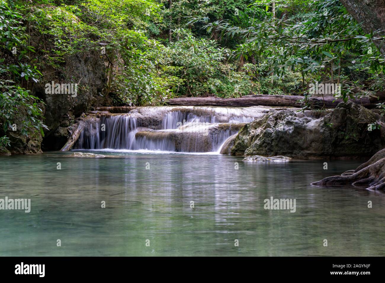 Clean green emerald water from the waterfall Surrounded by small trees - large trees,  green colour, Erawan waterfall, Kanchanaburi province, Thailand Stock Photo