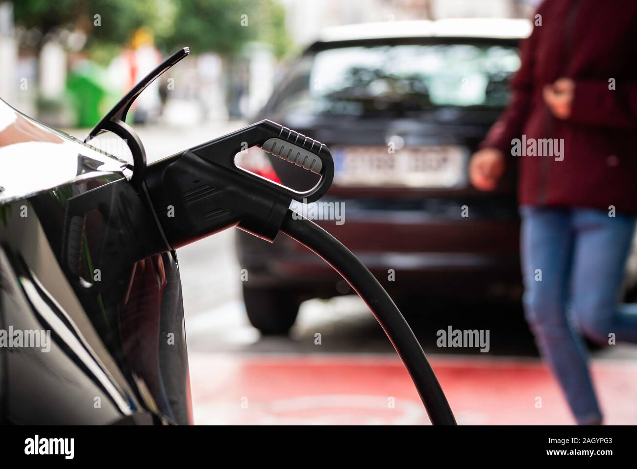 Close up of recharging of electric car in a charging port in Gijon, Asturias, Spain. Stock Photo