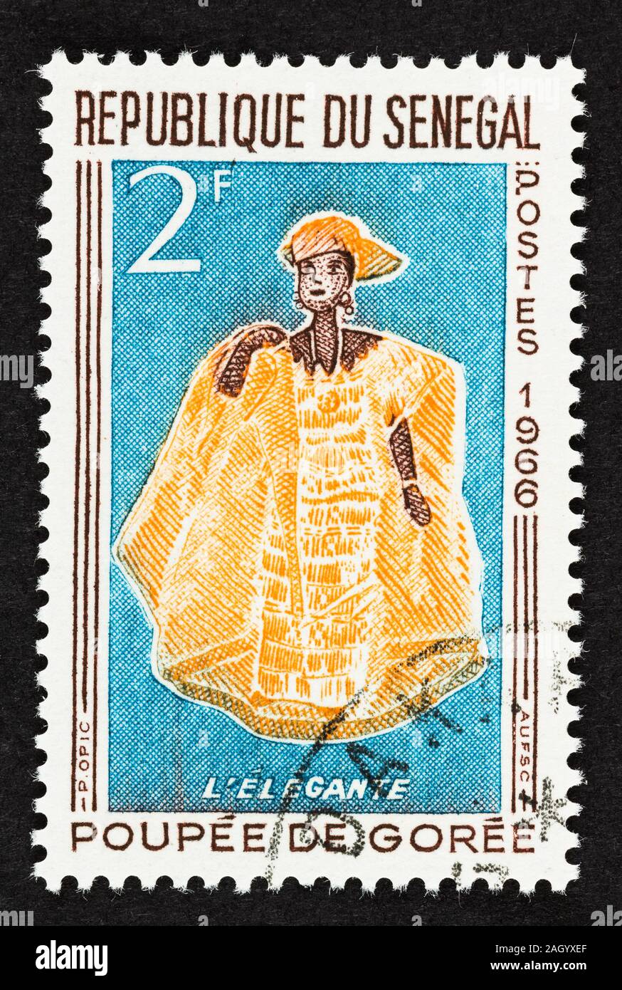 SEATTLE, WASHINGTON - September 25, 2019: Close up of Senegal postage stamp featuring dolls of Goree  in traditional costume issued in 1966. Stock Photo