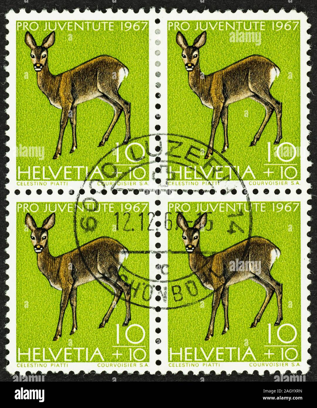 Close up of Pro Juventute postage of Switzerland with Roe deer. A block of 4 green 10+10 centime surcharged  postage stamps issued for charity in 1967. Stock Photo