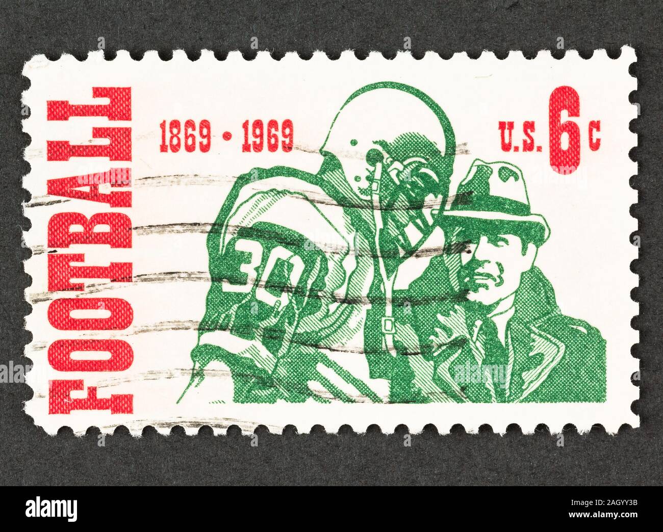 American 64 cent stamp commemorating 100th anniversary of Intercollegiate Football, issued in 1969, Scott # 1382. Stamp depicts a coach with player. Stock Photo