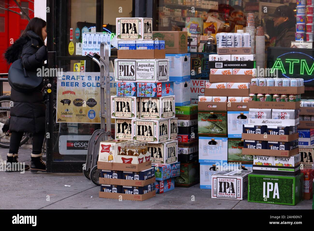 A delivery of beer and beverages sitting outside a convenience store in New York, NY Stock Photo