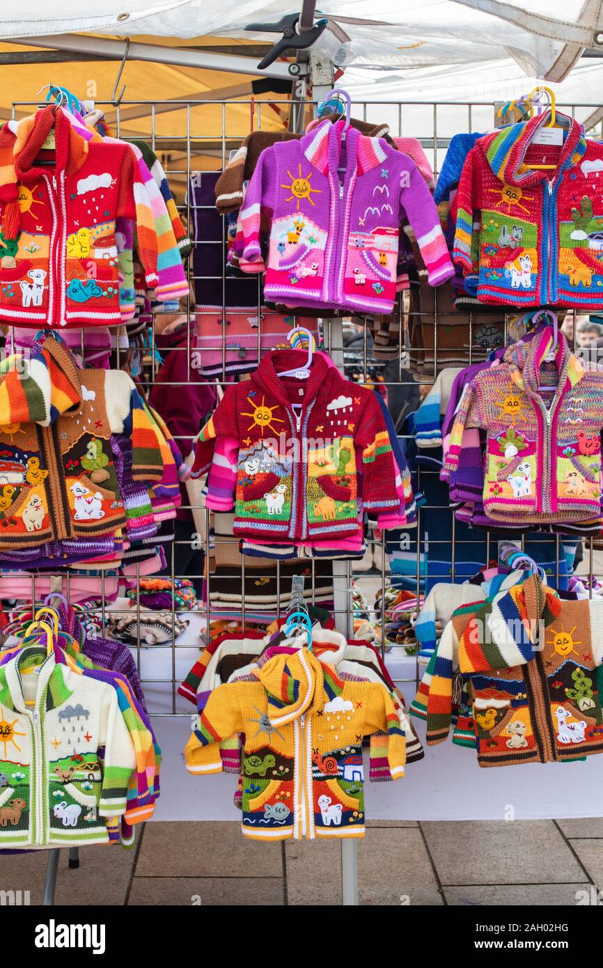 Colourful childrens jumpers on a  stall at a victorian christmas market. Stratford Upon Avon, Warwickshire, England Stock Photo