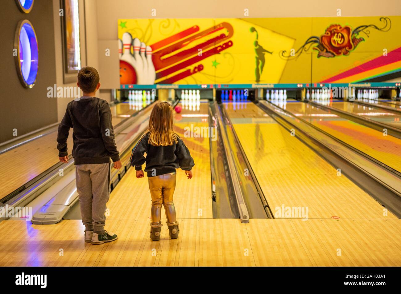 Beautiful scenery of school kids playing bowling at the sport club, kid