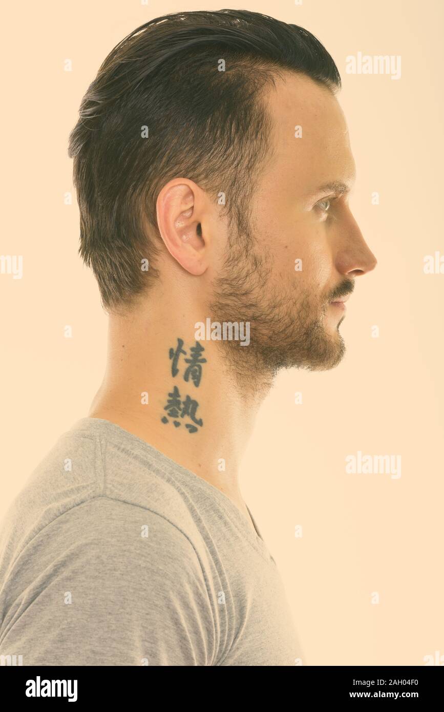 Profile view of face of young man with tattoo on neck Stock Photo
