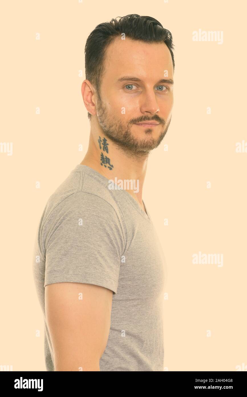 Studio shot of young man with tattoo on neck Stock Photo