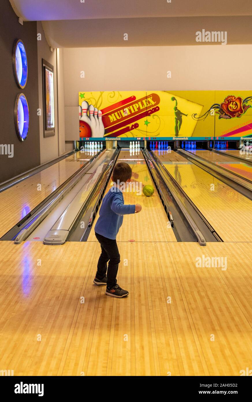 Beautiful scenery of school kids playing bowling at the sport club, kid