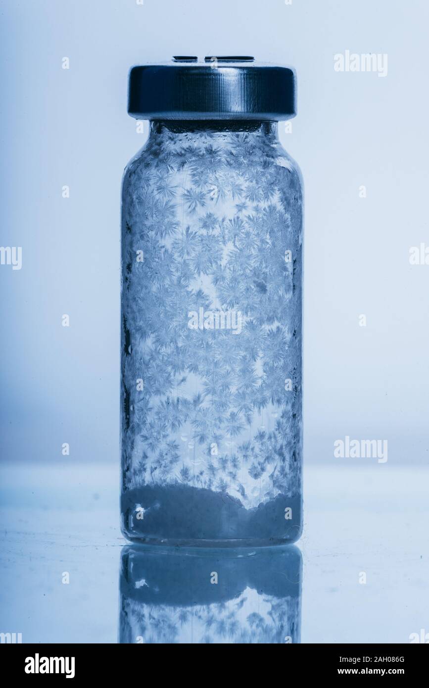 Glass medical ampoule vial for injection. Medicine is dry white drug