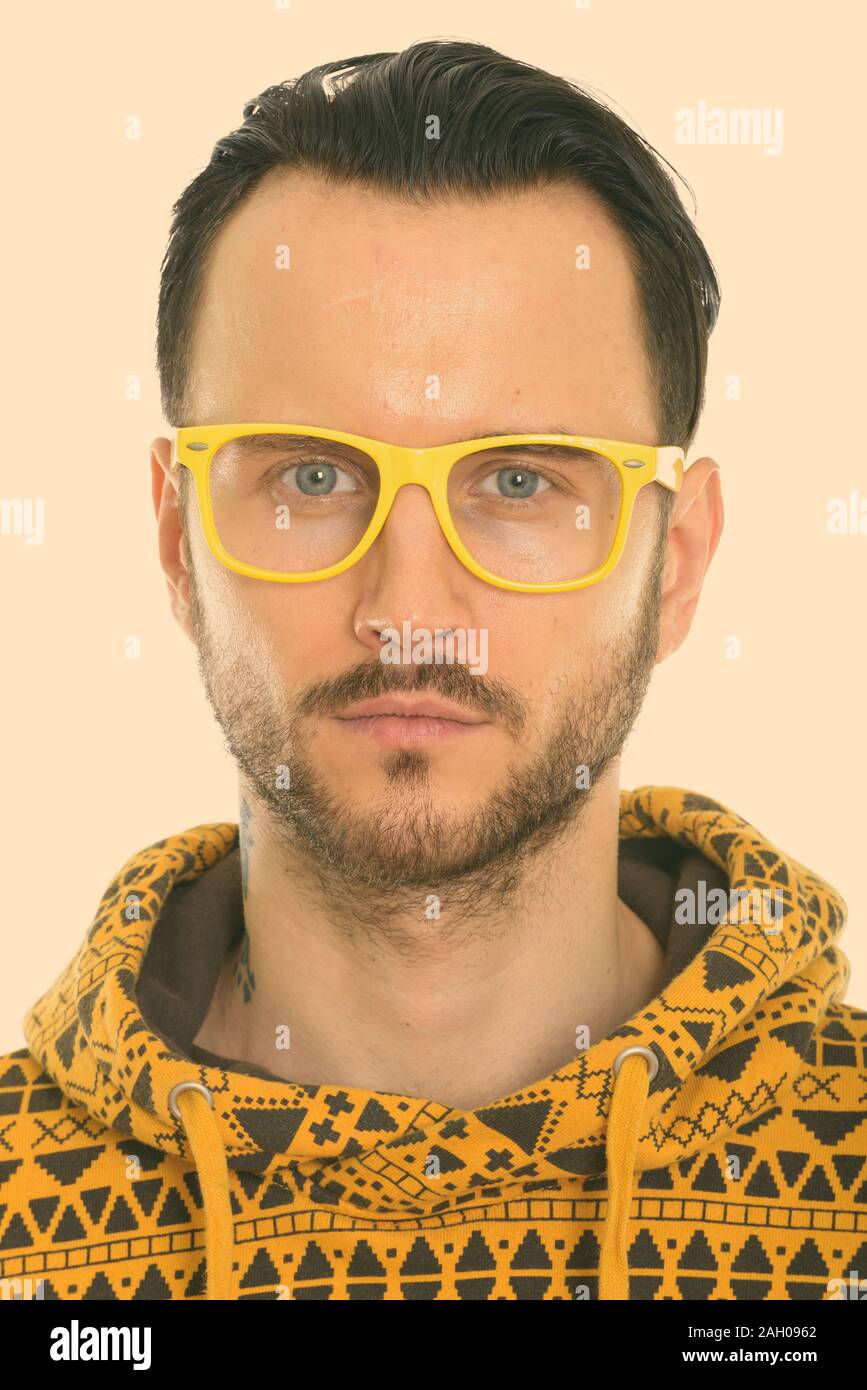 Face of young man wearing yellow eyeglasses Stock Photo