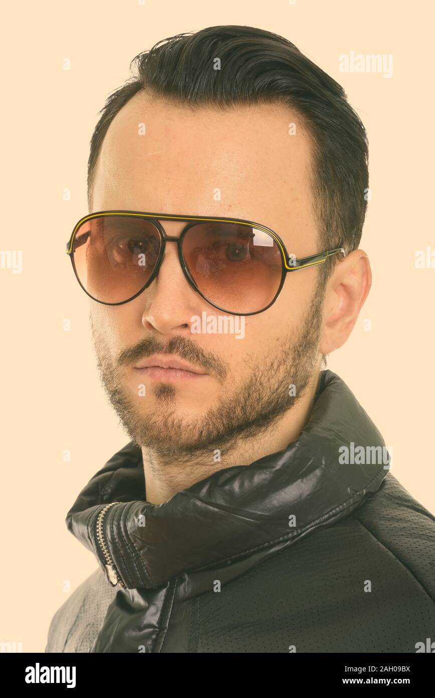 Face of cool young man wearing sunglasses with collar down Stock Photo