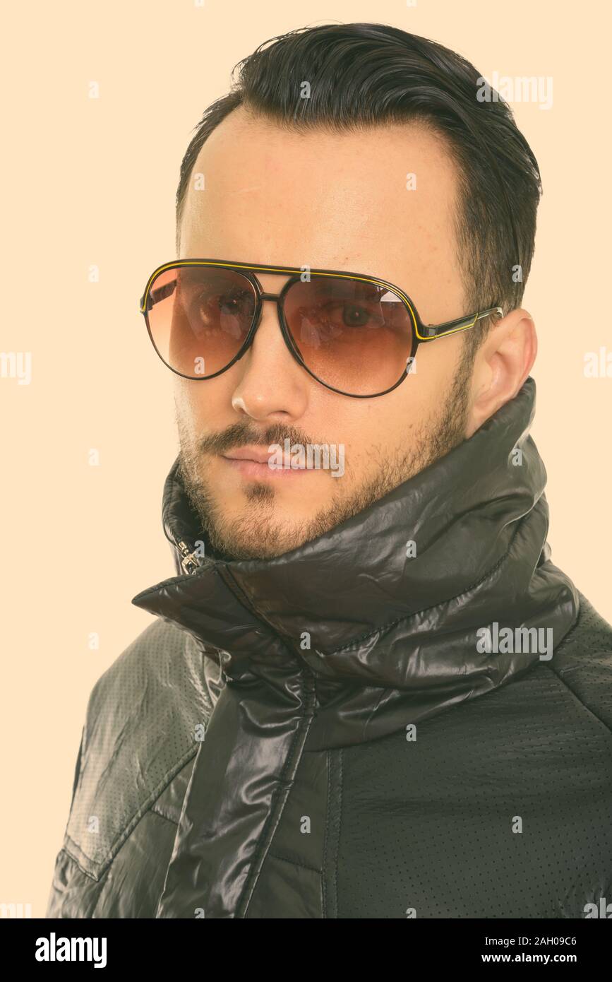 Face of cool young man wearing sunglasses with collar up Stock Photo