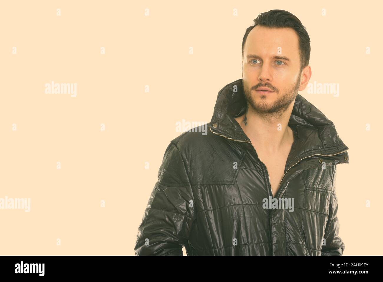 Studio shot of cool young man thinking while looking at distance Stock Photo