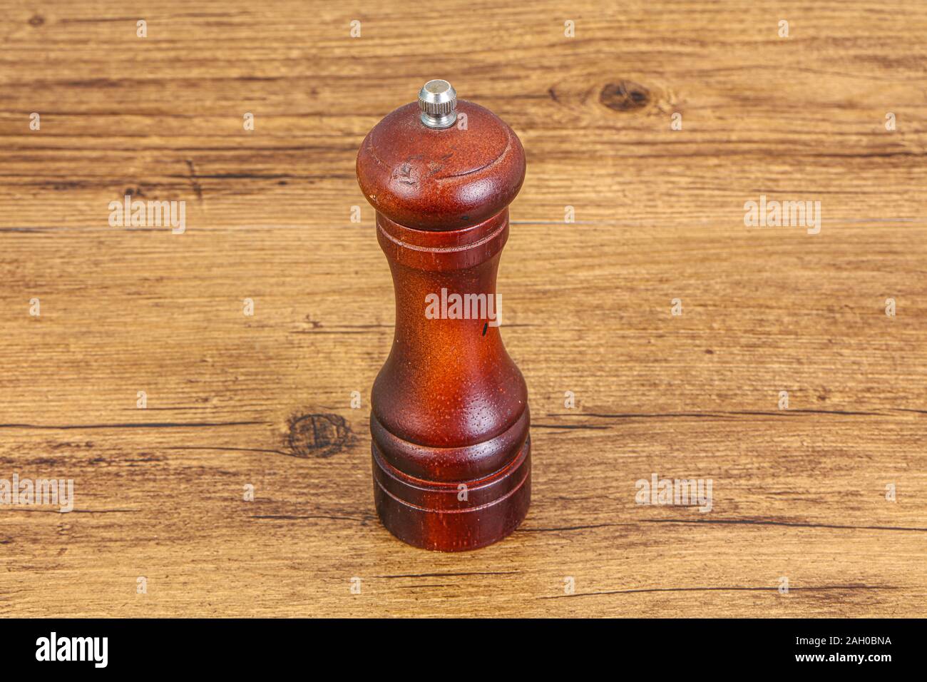 Wooden pepper mill for seasonong over background Stock Photo