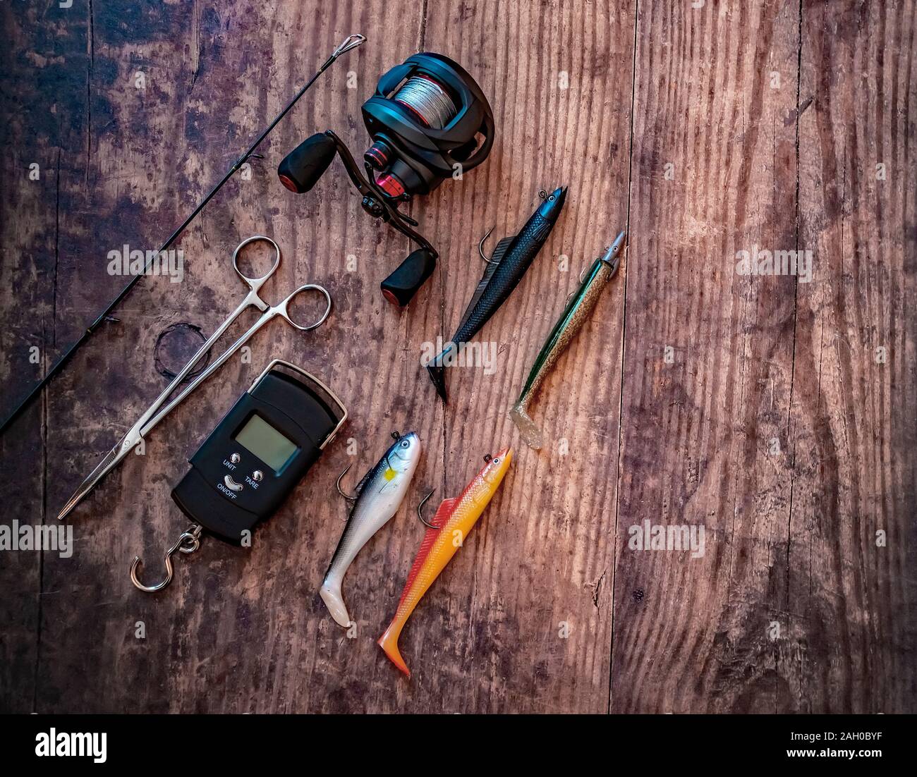 Flat lay of bass lure fishing tackle on a plain wooden background Stock  Photo - Alamy