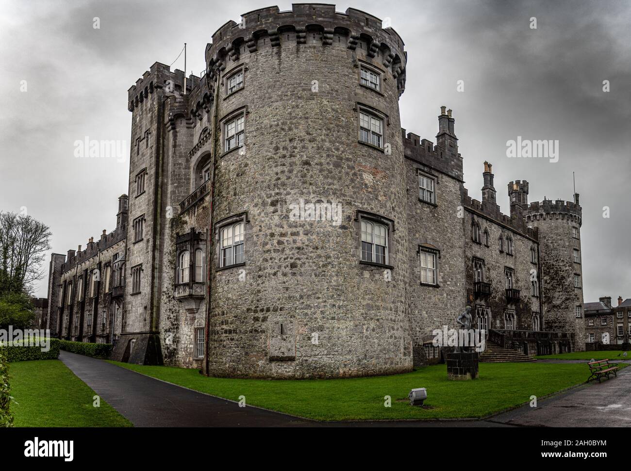 KILKENNY, IRELAND, DECEMBER 23, 2018: Kilkenny Castle seen from the corner of its entrance on a dramatic cloudy day. Stock Photo