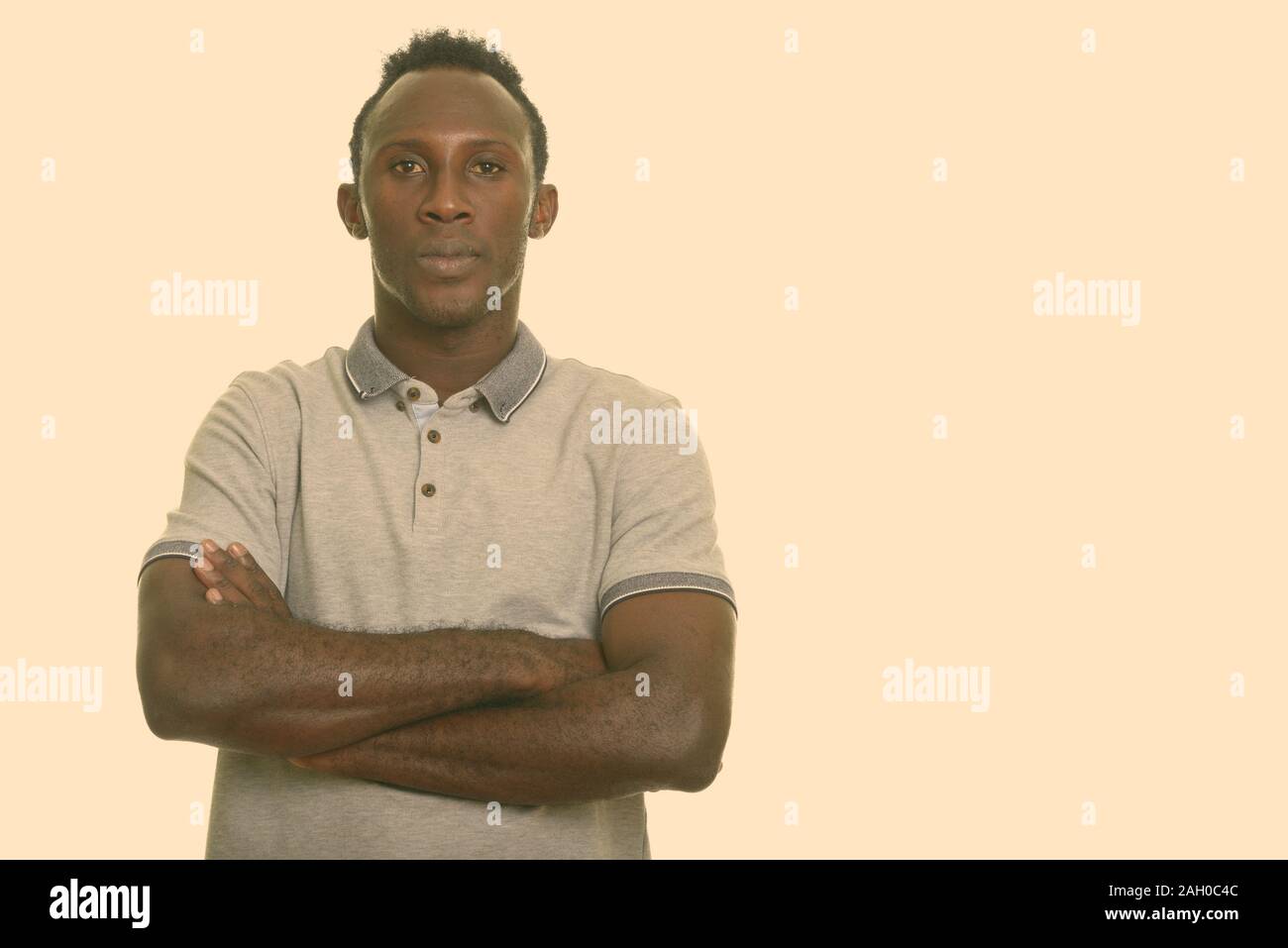Young black African man with arms crossed Stock Photo - Alamy
