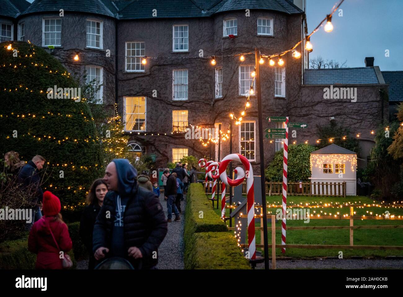 KILKENNY, IRELAND, DECEMBER 23, 2018 People in christmas market, waking along a decorated and