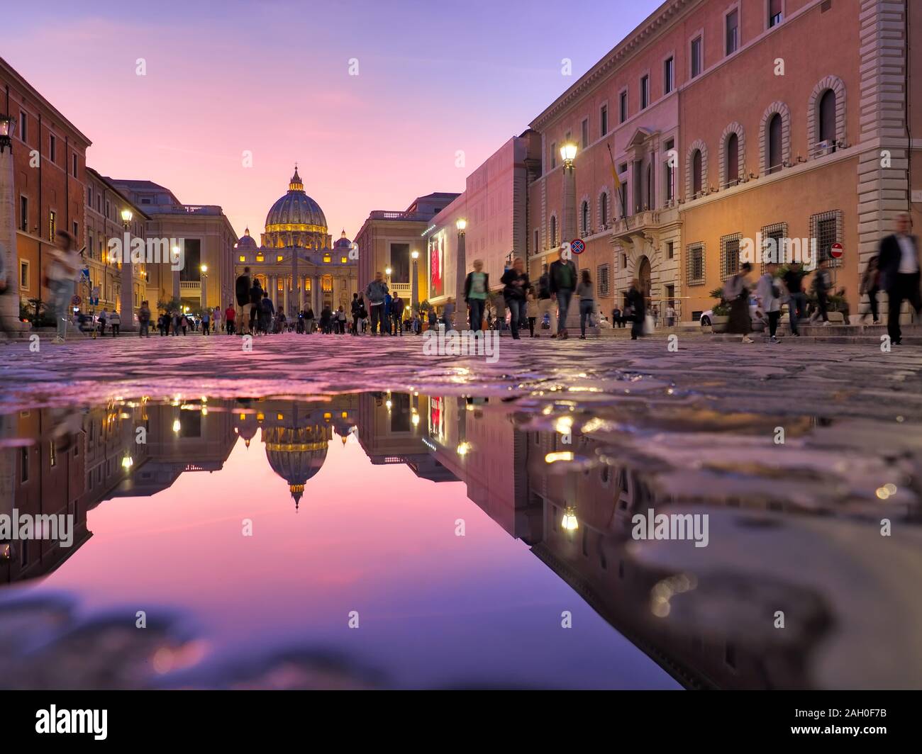 Wonderful view of St Peter Cathedral, Vatican, Rome, Italy. Sunset sky with night city lights Stock Photo