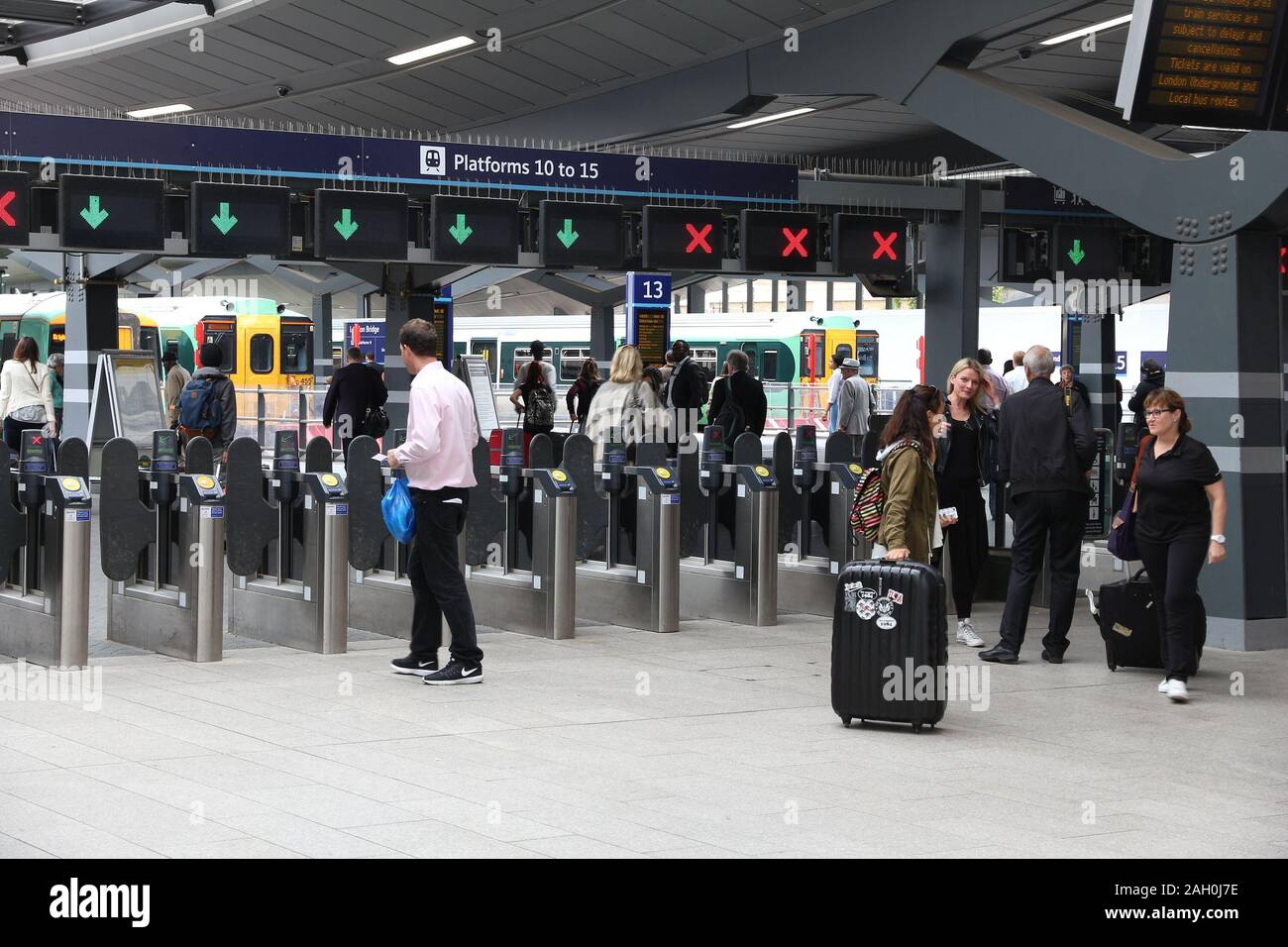 LONDON, UK - JULY 8, 2016: Passengers check in with contactless tickets at London Bridge railway station. With 47 million annual passengers, it's the Stock Photo