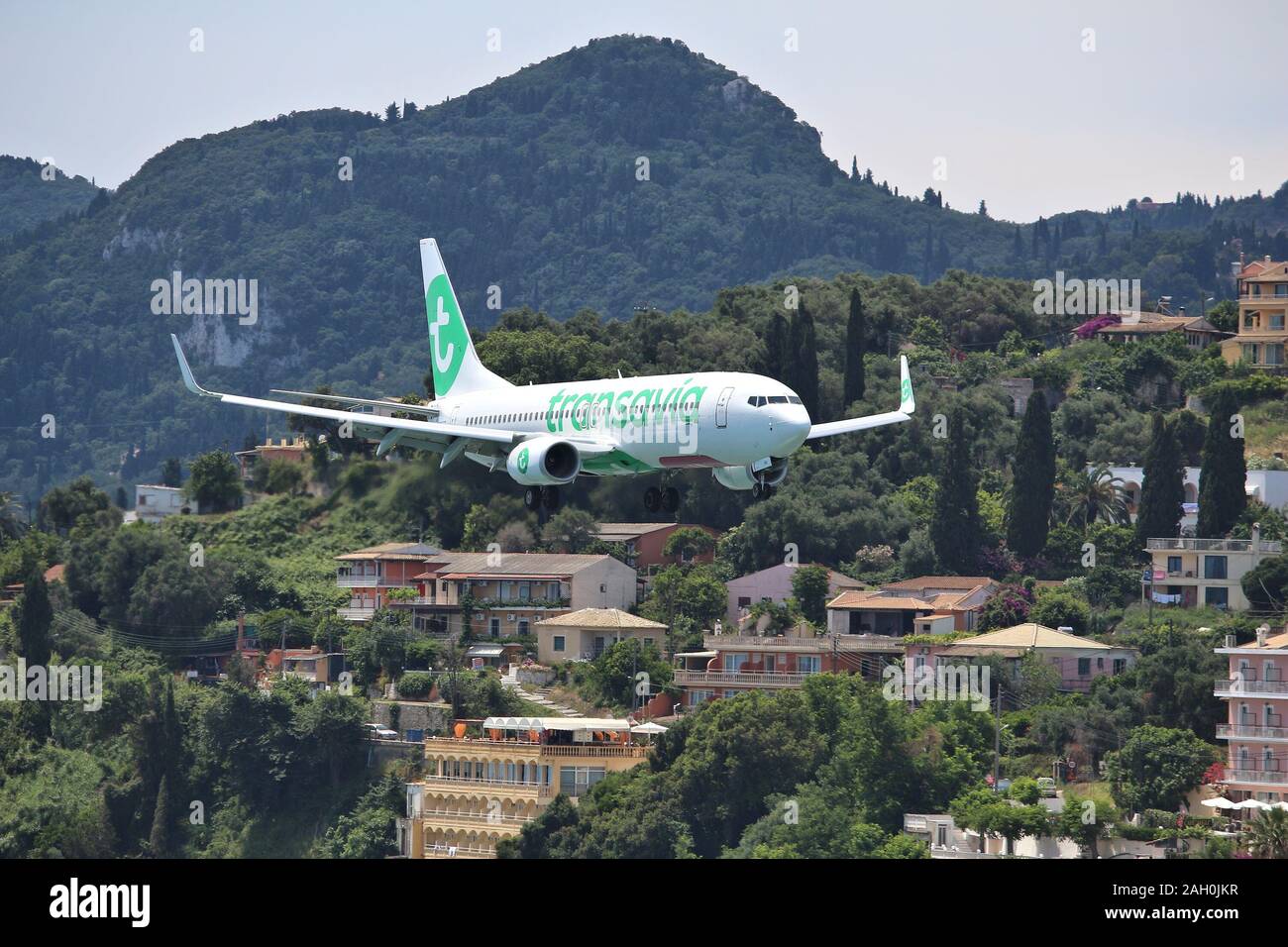 CORFU, GREECE - JUNE 5, 2016: Transavia Boeing 737-800 arrives at Corfu International Airport, Greece. Transavia is a Dutch low-cost airline owned by Stock Photo