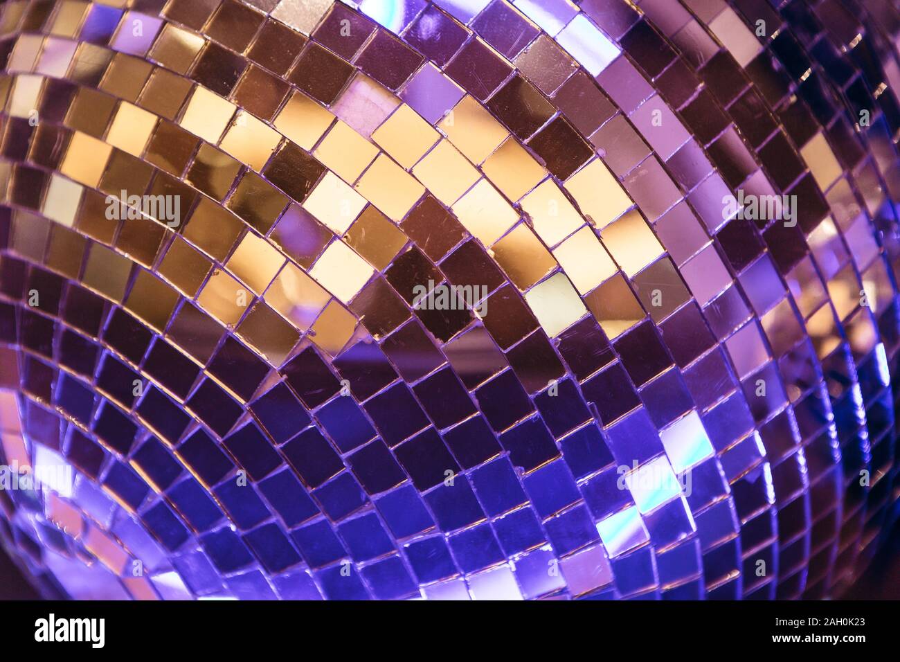 Wall Mural sparkling golden disco ball on a glowing purple background 