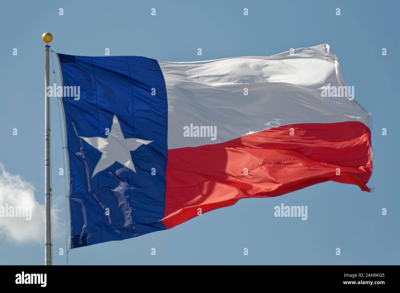 The State Flag of Texas fluttering in a strong wind at the Fort Bend County State Fair in Katy, Houston. Stock Photo