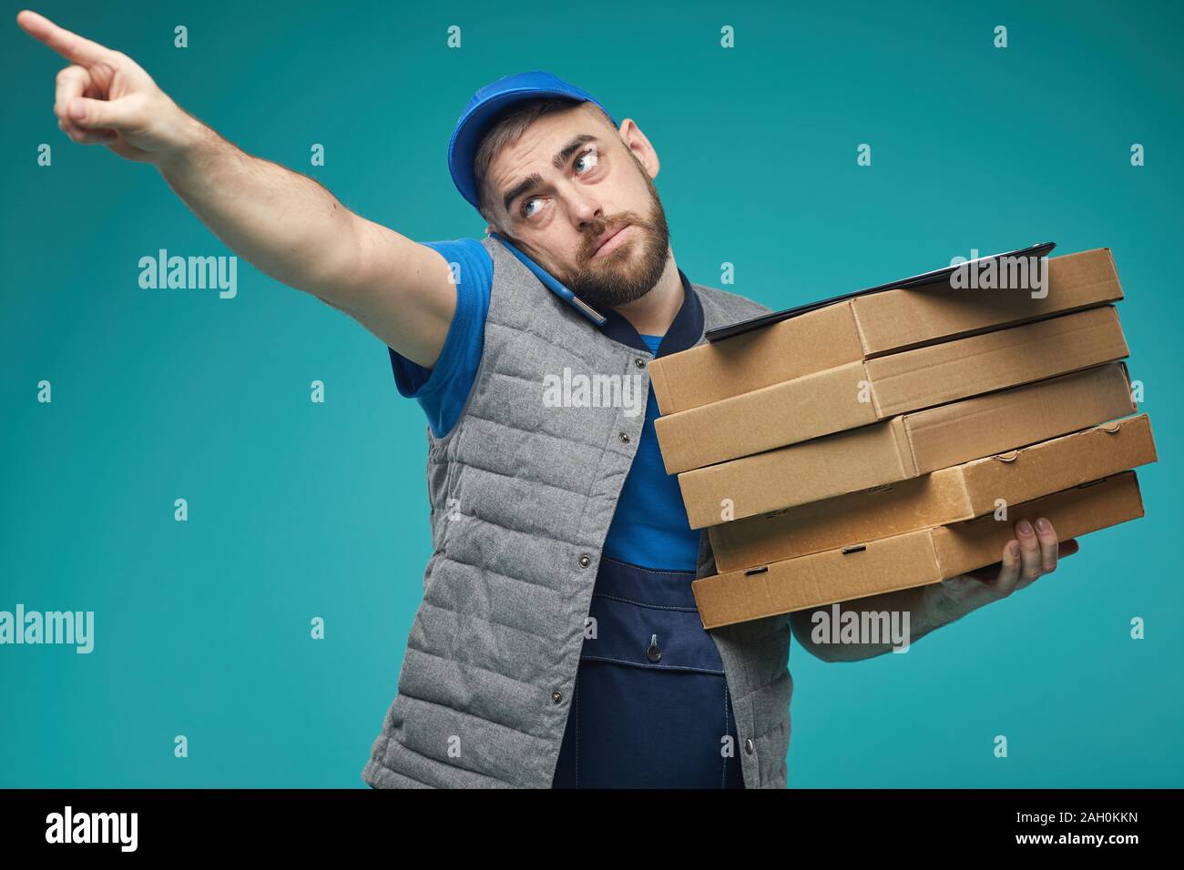 Horizontal medium studio shot of food delivery male worker holding