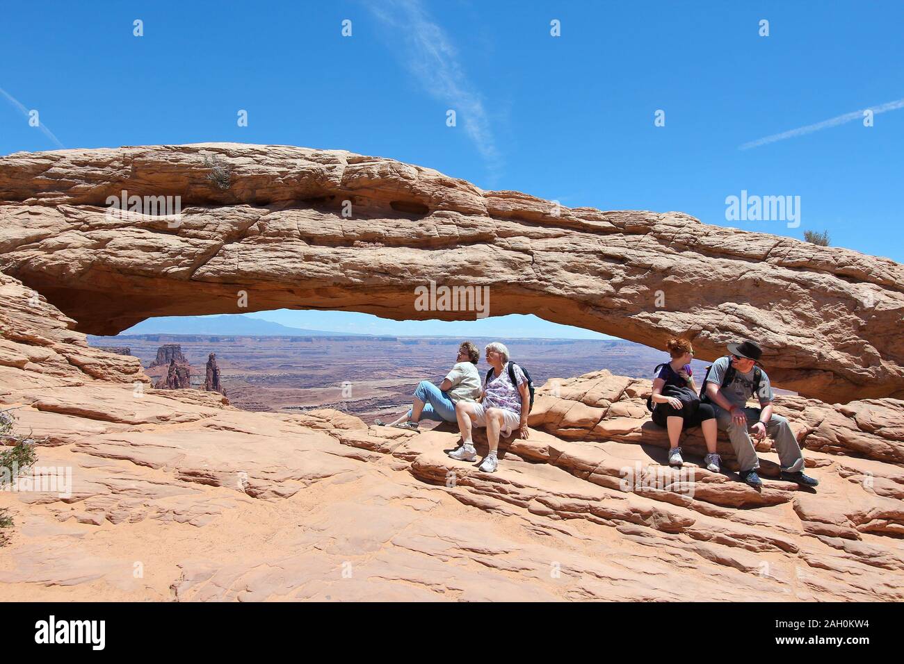 CANYONLANDS, UNITED STATES - JUNE 22, 2013: People visit Mesa Arch in Canyonlands National Park, USA. More than 452,000 people visited Canyonlands NP Stock Photo