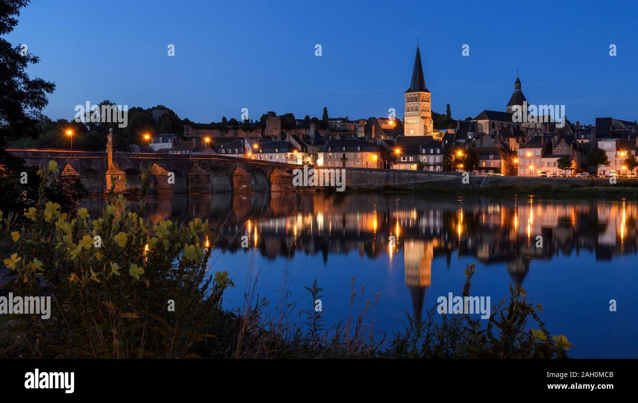 La Charité sur Loire, a typical french village in Burgundy (FRANCE) reflecting on the river Loire at the blue hour. Stock Photo