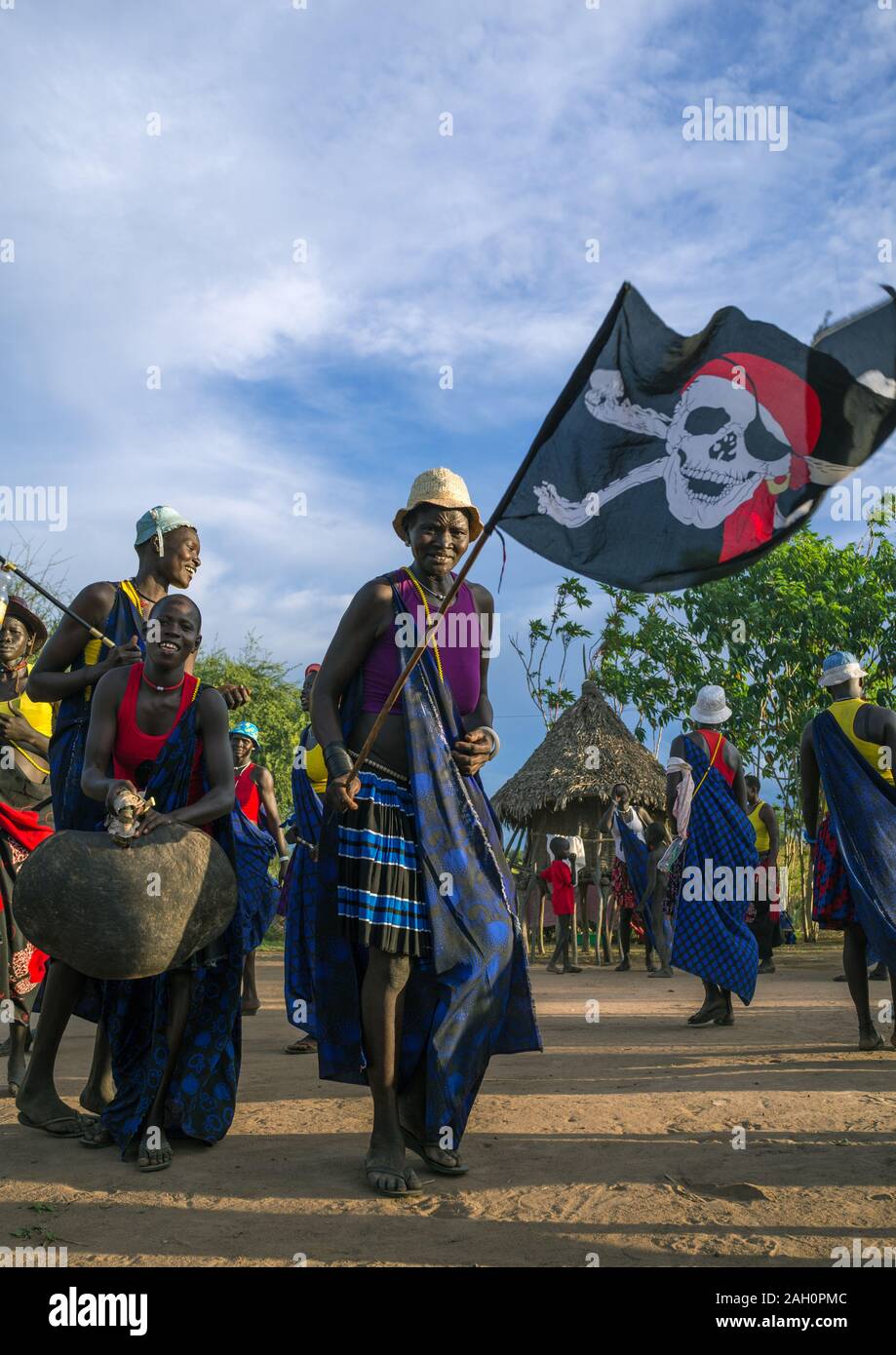 Mundari tribe women with a pirate flag while celebrating a wedding, Central Equatoria, Terekeka, South Sudan Stock Photo
