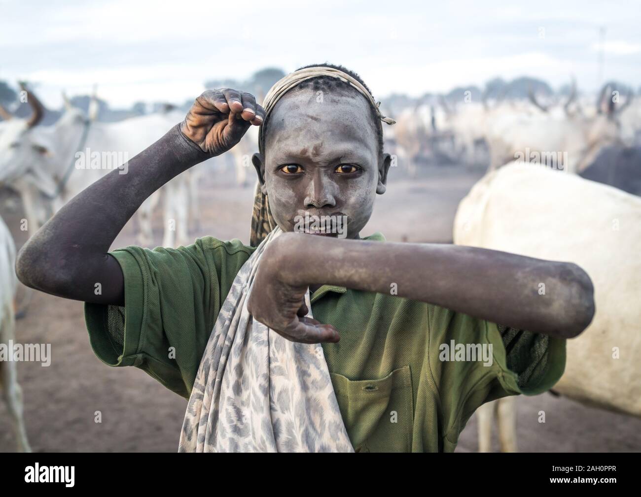 A Mundari tribe boy mimics the position of horns of his favourite cow, Central Equatoria, Terekeka, South Sudan Stock Photo