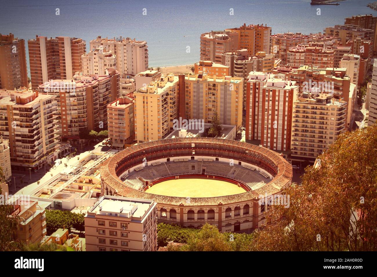 Malaga in Andalusia region of Spain. Famous bull ring stadium. Cross processed color tone - retro image filtered style. Stock Photo