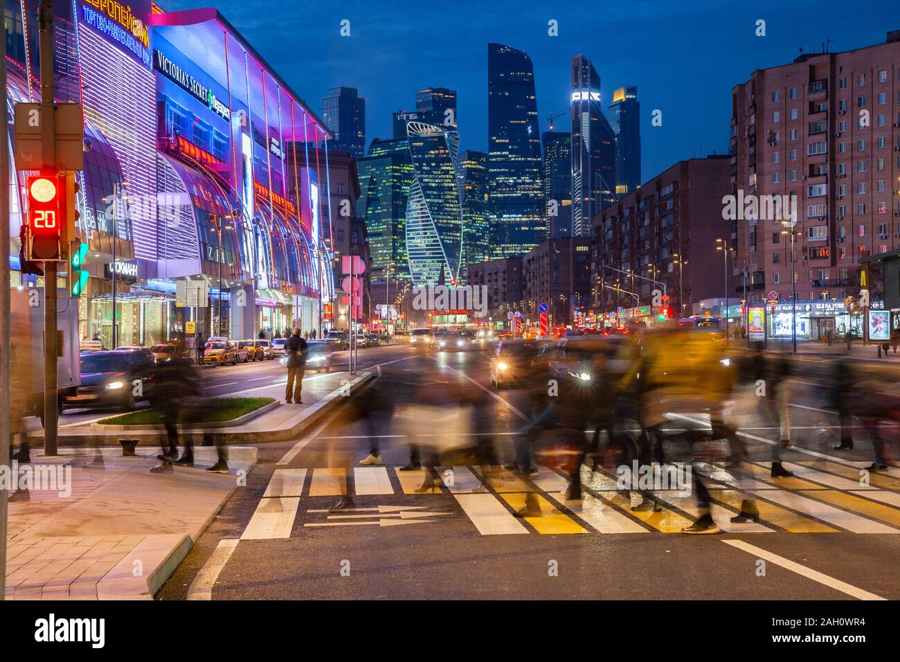 Moscow, Russia - November 15, 2018: Crowd of people crossing the Kutuzovsky Avenue with the Moscow City skyscrapers seen on the background on November Stock Photo