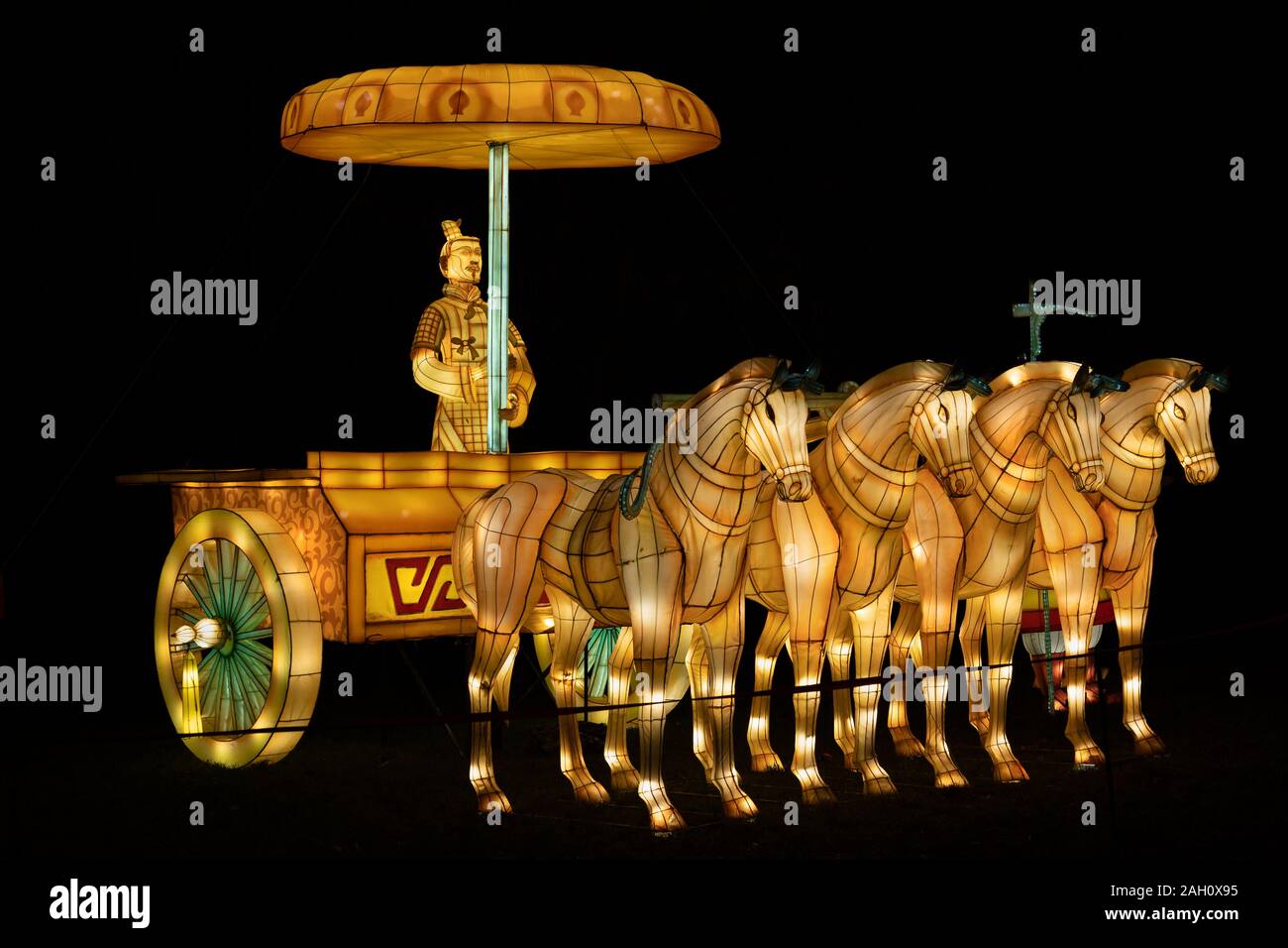 Warsaw, Poland - December 16, 2019: Emperor in chariot and four horses at Chinese Light Festival, traditional Chinese culture exhibition at night at F Stock Photo