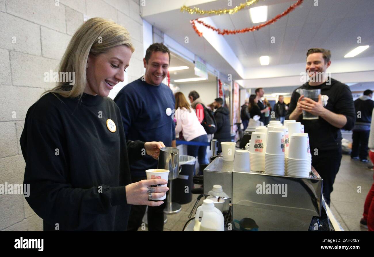 Ellie Goulding serves coffee to a guest while volunteering at a Crisis Christmas centre in London, as the charity opens its doors to homeless people for the festive period. Stock Photo