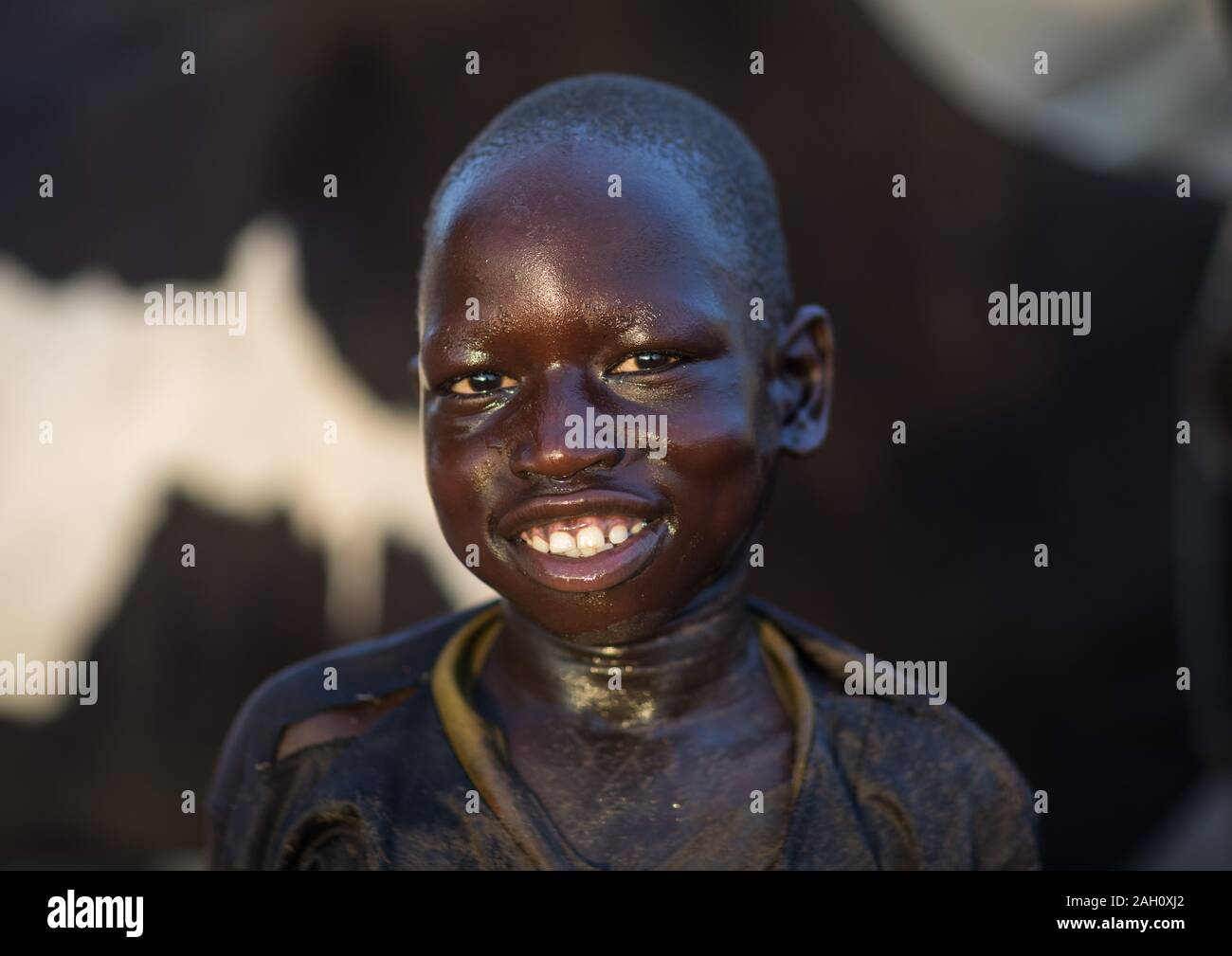 Smiling Mundari tribe boy after showering in the cow urine to dye his ...