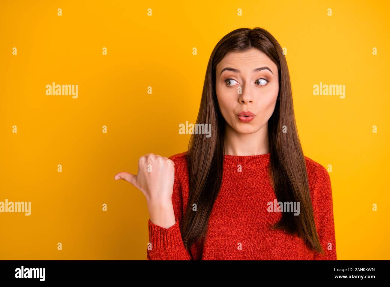 Photo of cute funny beautiful attractive girl pointing at empty space with  her thumb for you to subscribe her social media account isolated over Stock  Photo - Alamy