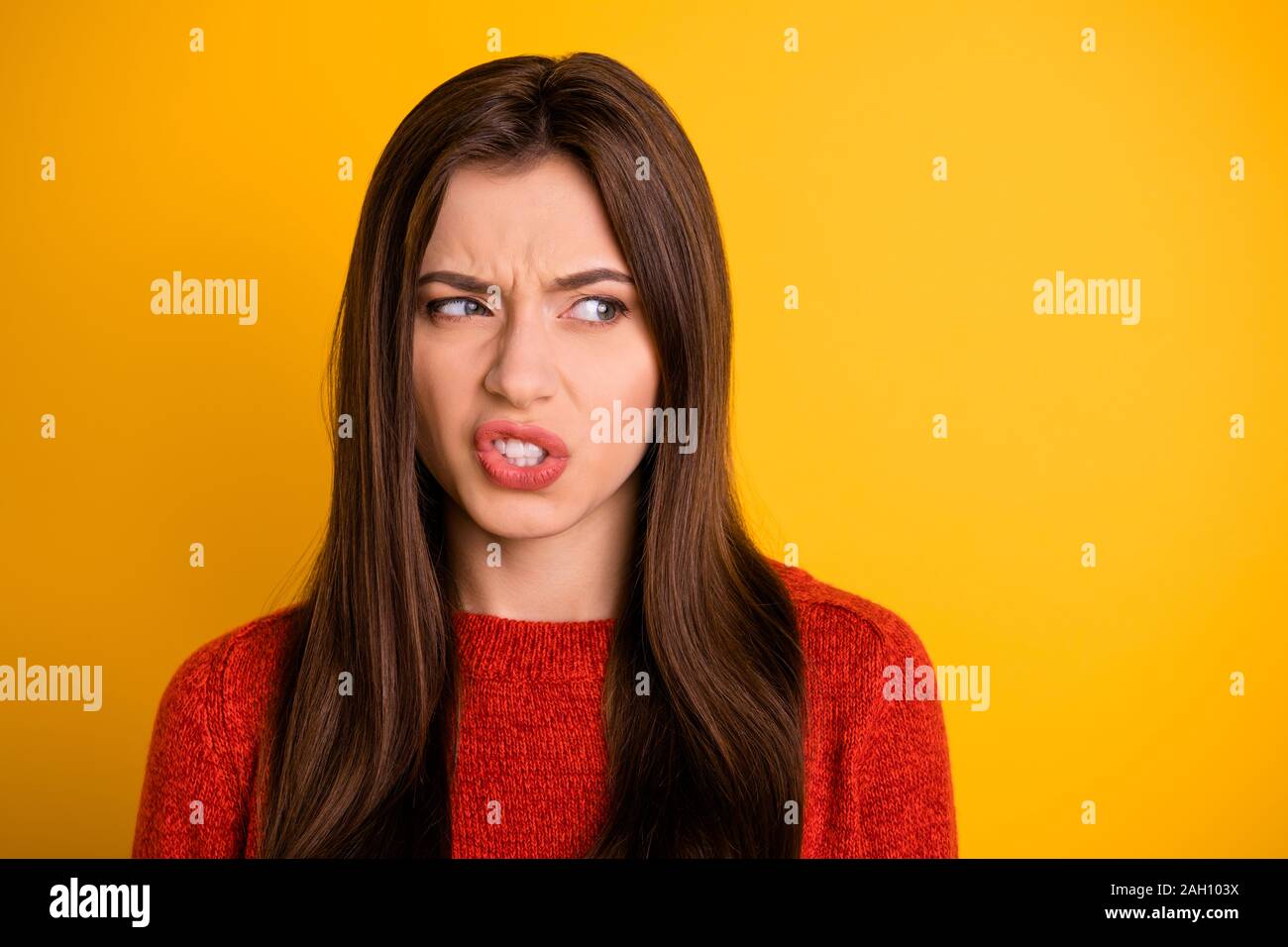 Portrait of mad annoyed person look see ugly object grimace dislike emotion expression concept wear red pullover sweater isolated over yellow color Stock Photo